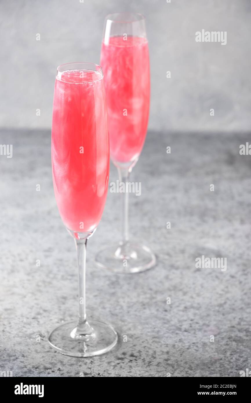 Two glasses of sparkling rose wine with shimmer glitter garnish ...