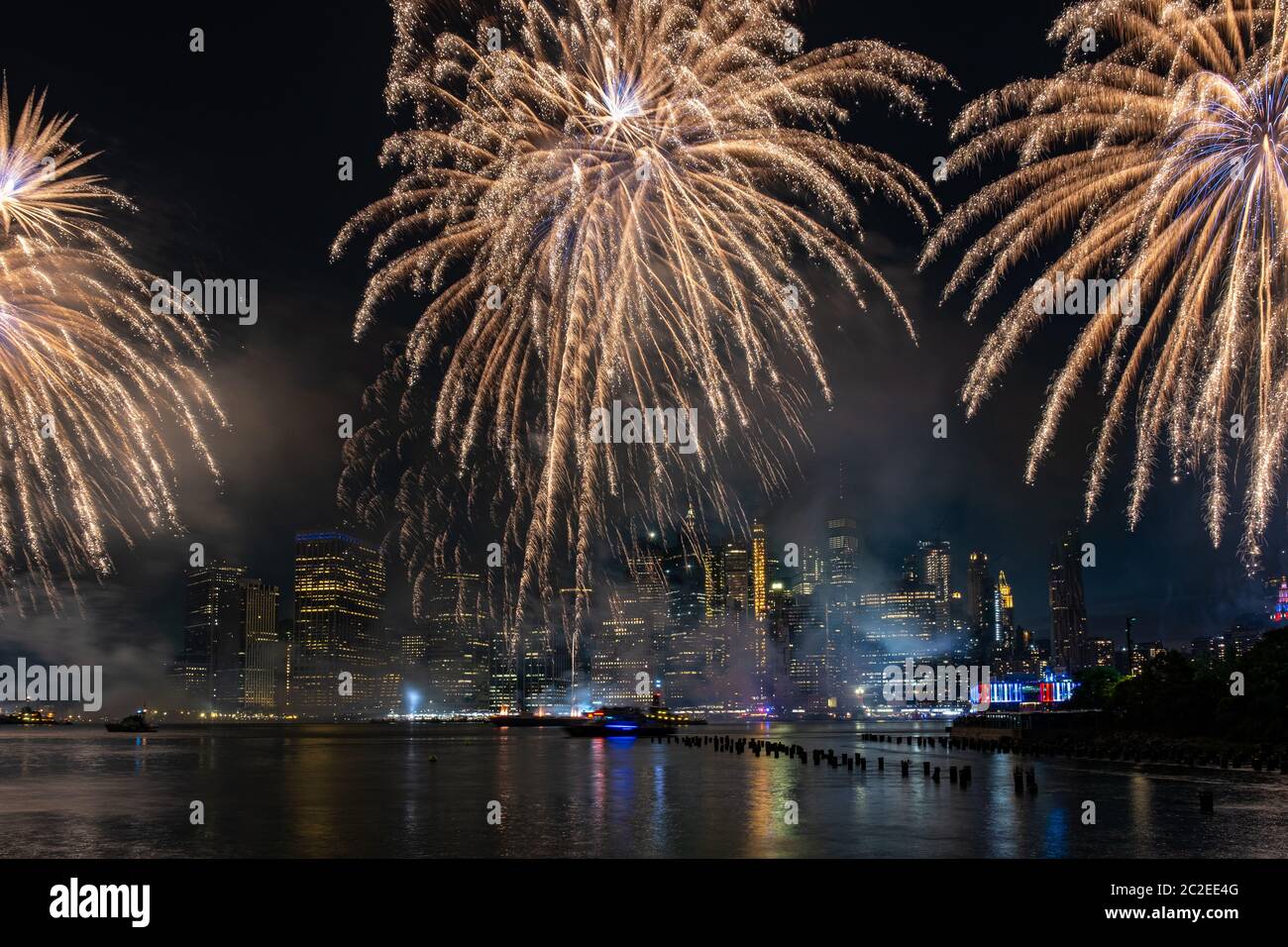 Macy's 4th of July Independence Day Fireworks show on east river with Lower Manhattan Skyline Stock Photo