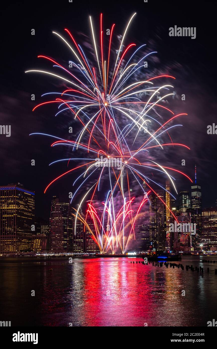 Macy's 4th of July Independence Day Fireworks show on east river with Lower Manhattan Skyline Stock Photo