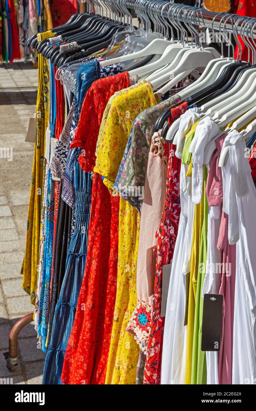 Clothes on a rack for sale at a market Stock Photo - Alamy