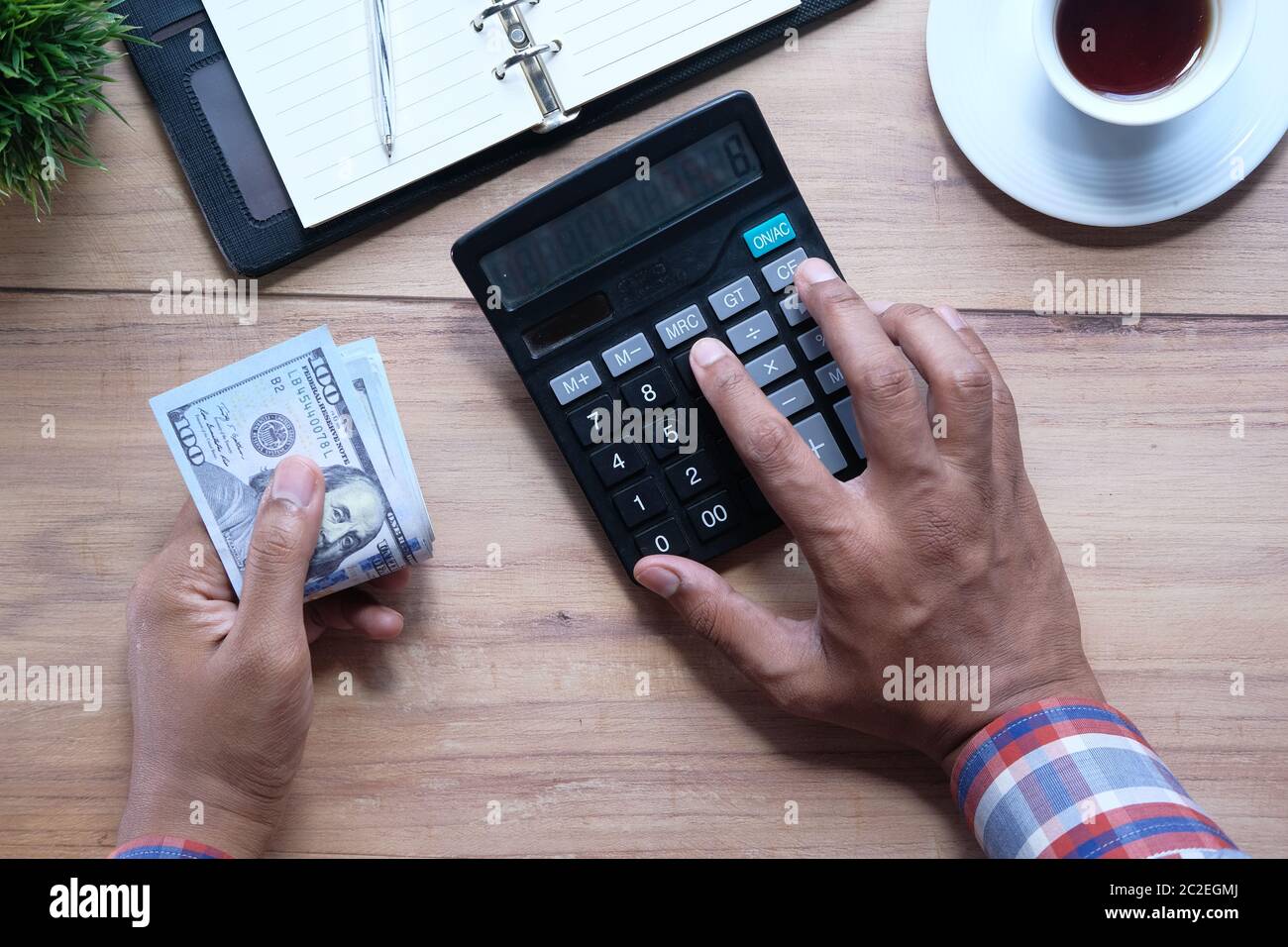 Man hand using calculator on office desk  Stock Photo