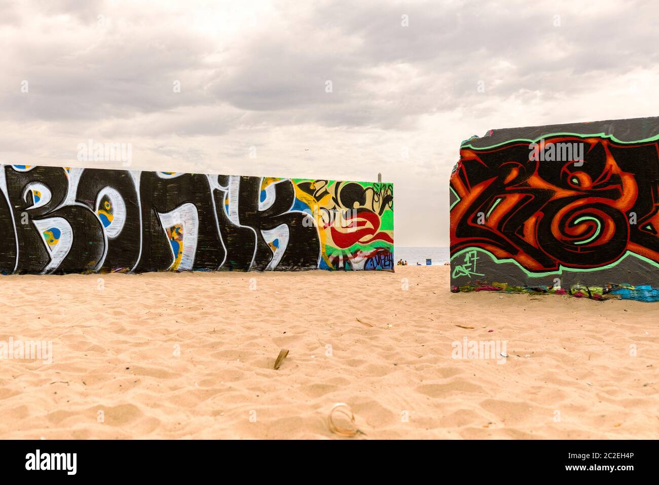 Graffitied murals in Venice Beach with limited sea view. Stock Photo