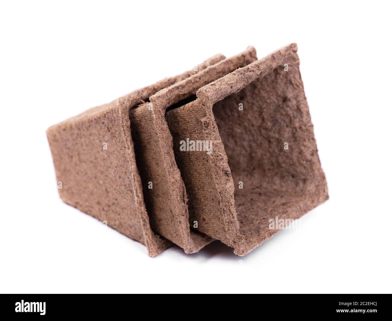Three empty peat pots isolated on white background Stock Photo