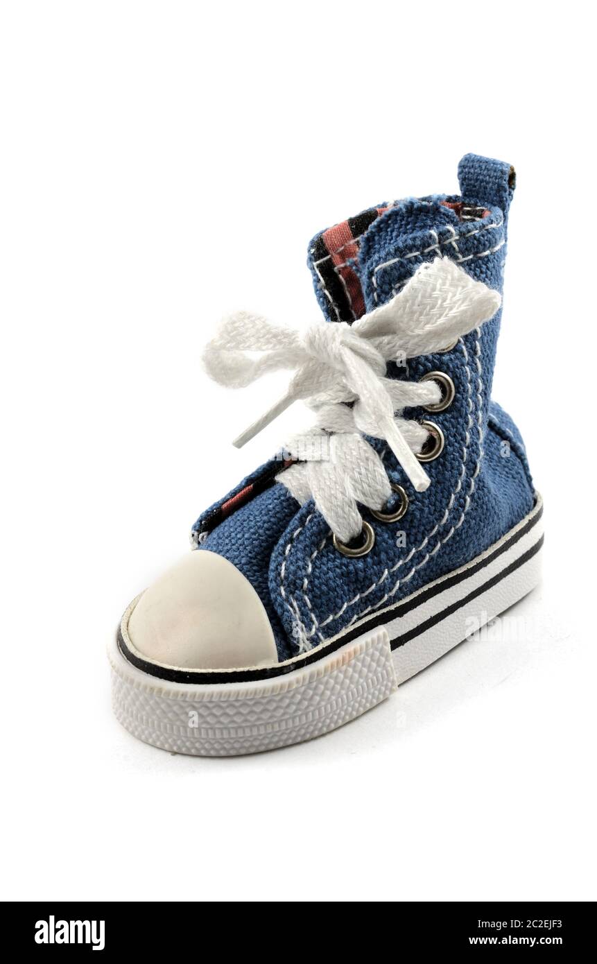 tiny denim shoe on a white Stock Photo