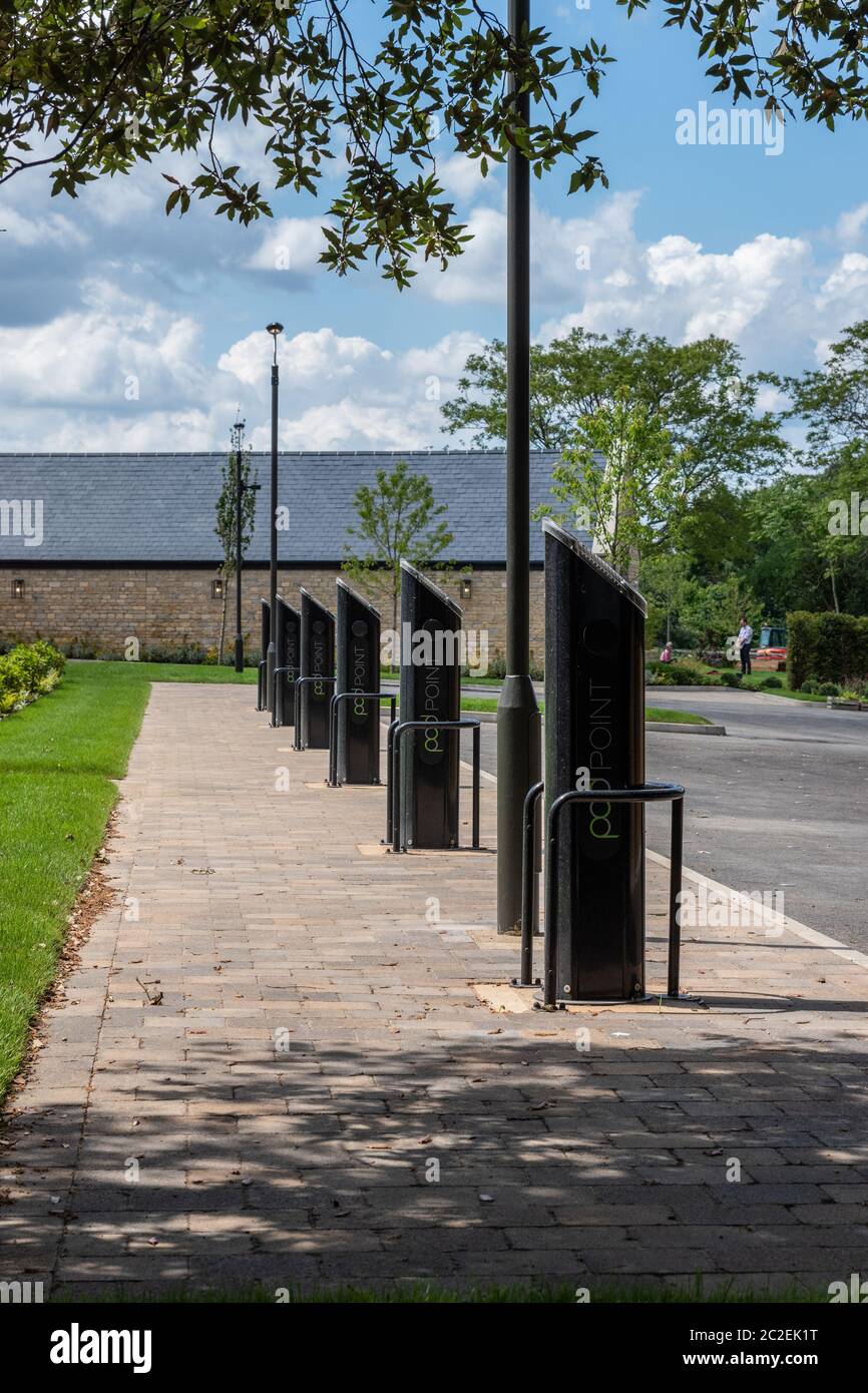 Row of car charging points at the newly renovated Falcon Hotel in the estate village of Castle Ashby, Northamptonshire, UK Stock Photo