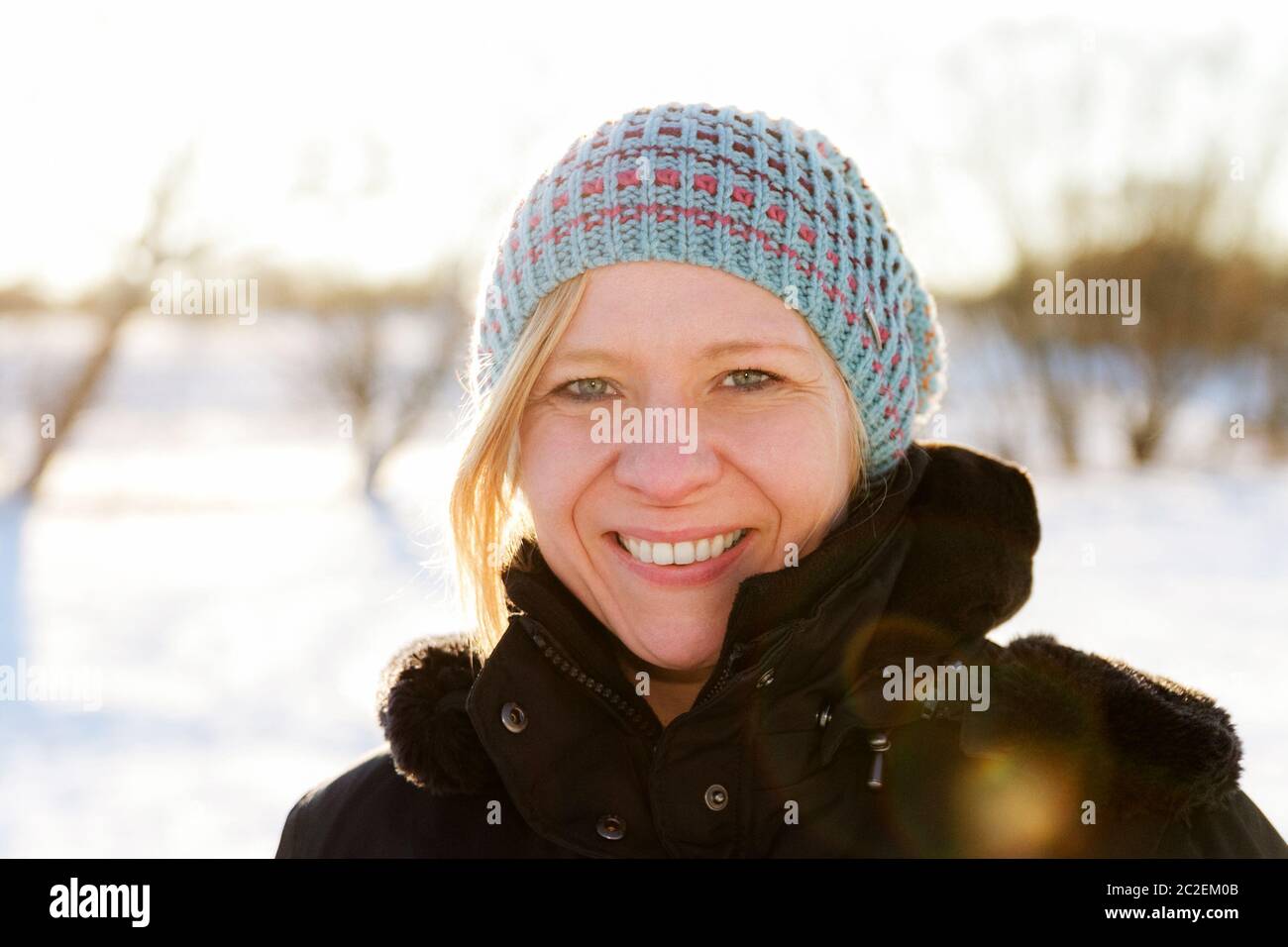 Blonde Woman Walking Outdoors In A Snowy Winter Landscape Scene