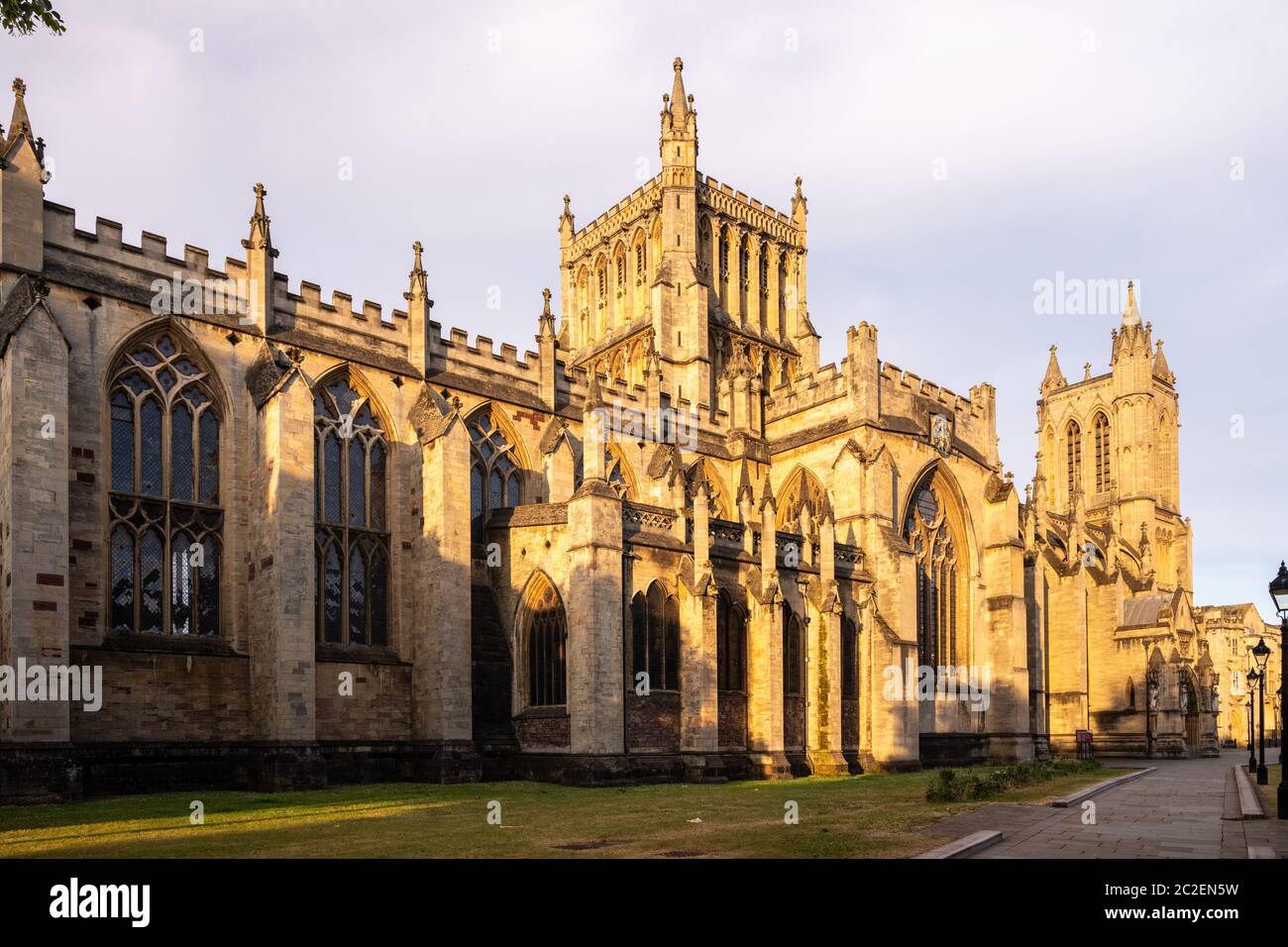 Dawn light falls on the gothic exterior of Bristol Cathedral beside College Green. Stock Photo