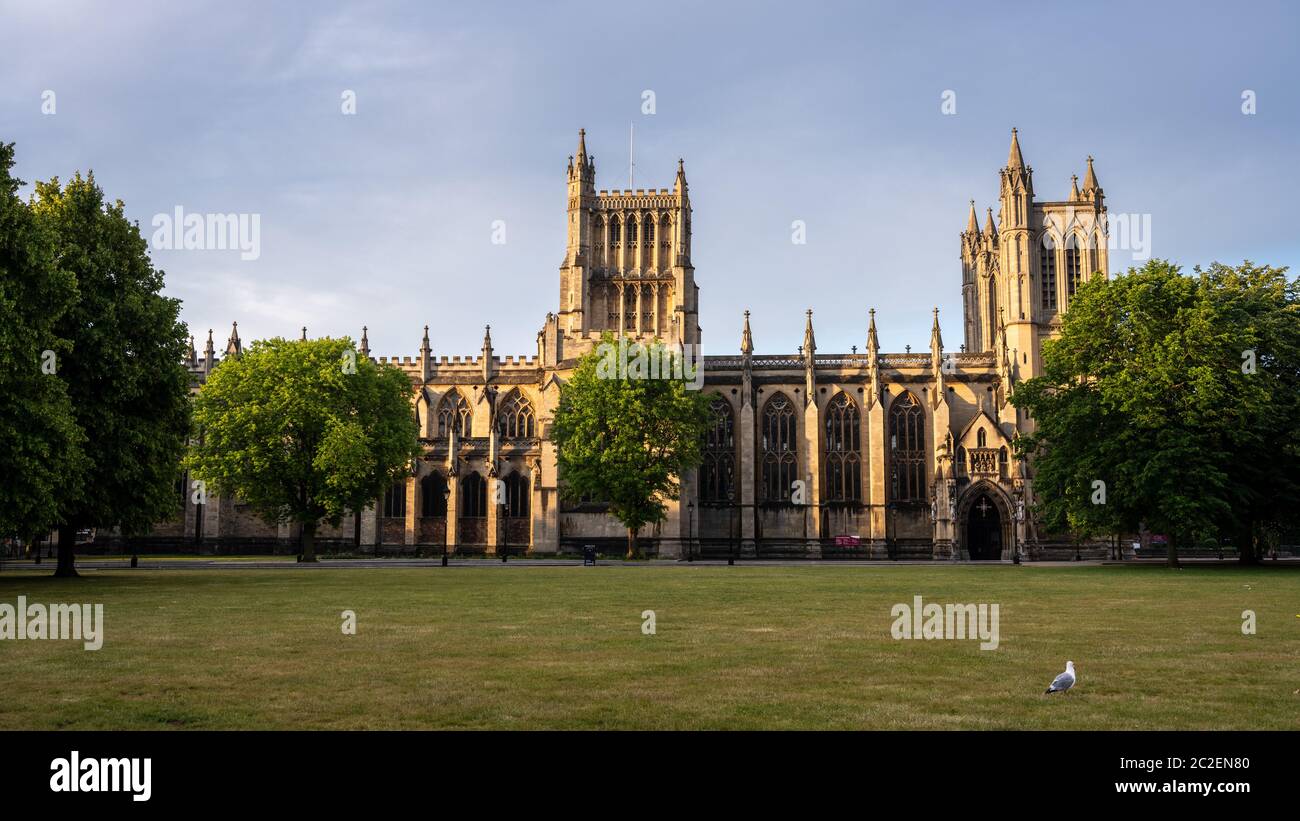 Dawn light falls on Bristol Cathedral beside College Green. Stock Photo