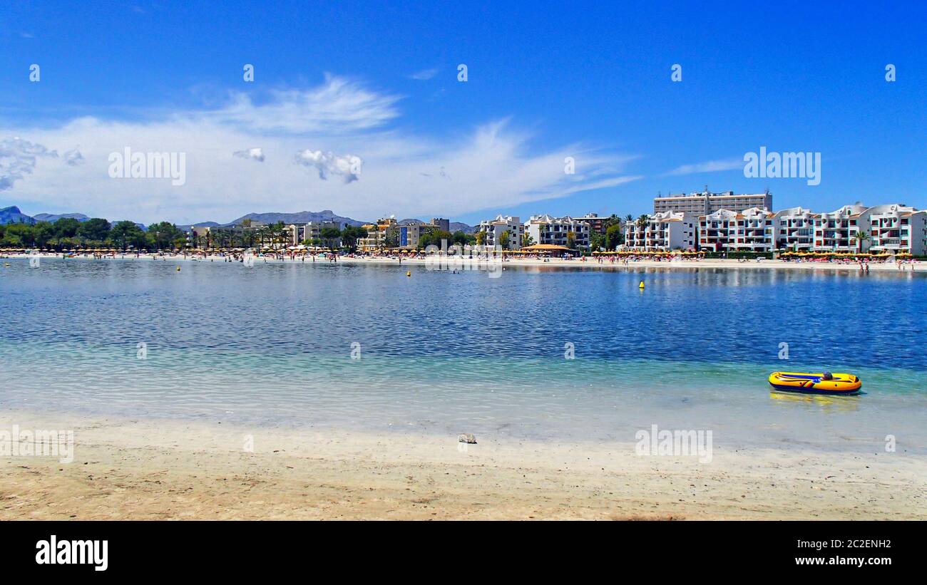 A yellow rubber inflatable yellow boat in the blue waters of the bay of