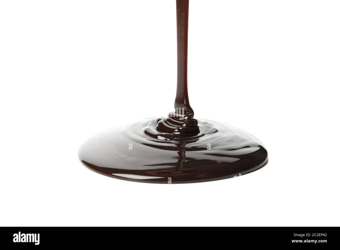 Melted chocolate is pouring, isolated on white background Stock Photo