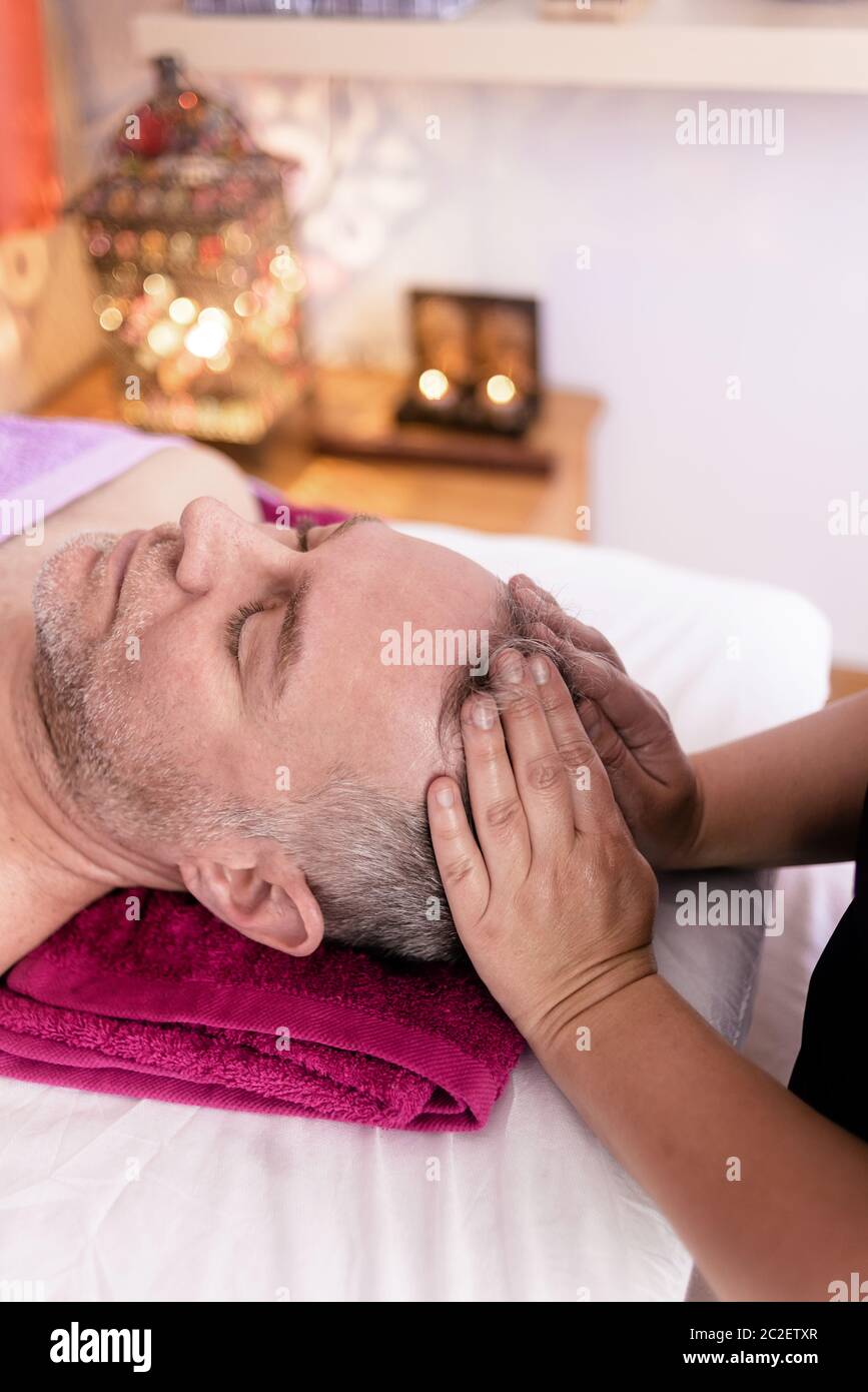 Female masseuse massaging a male patient