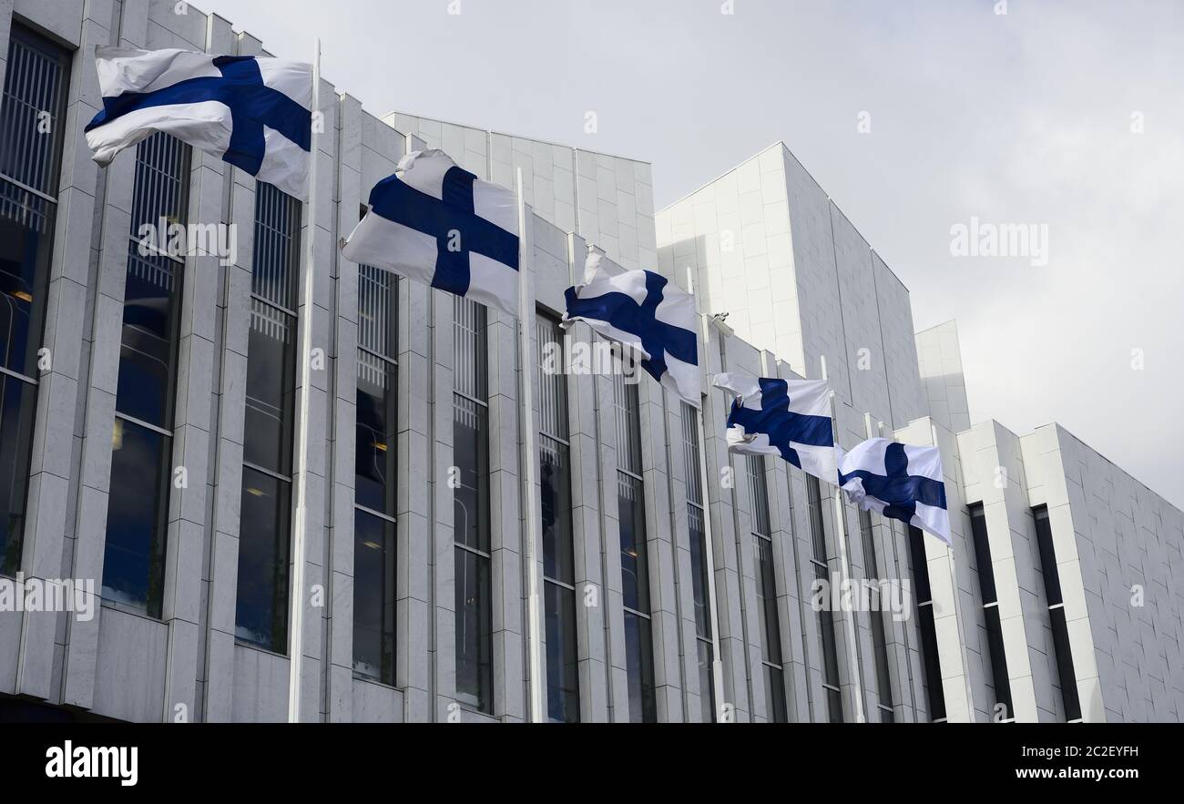 waving Finnish flags against of The Finlandia Hall Stock Photo