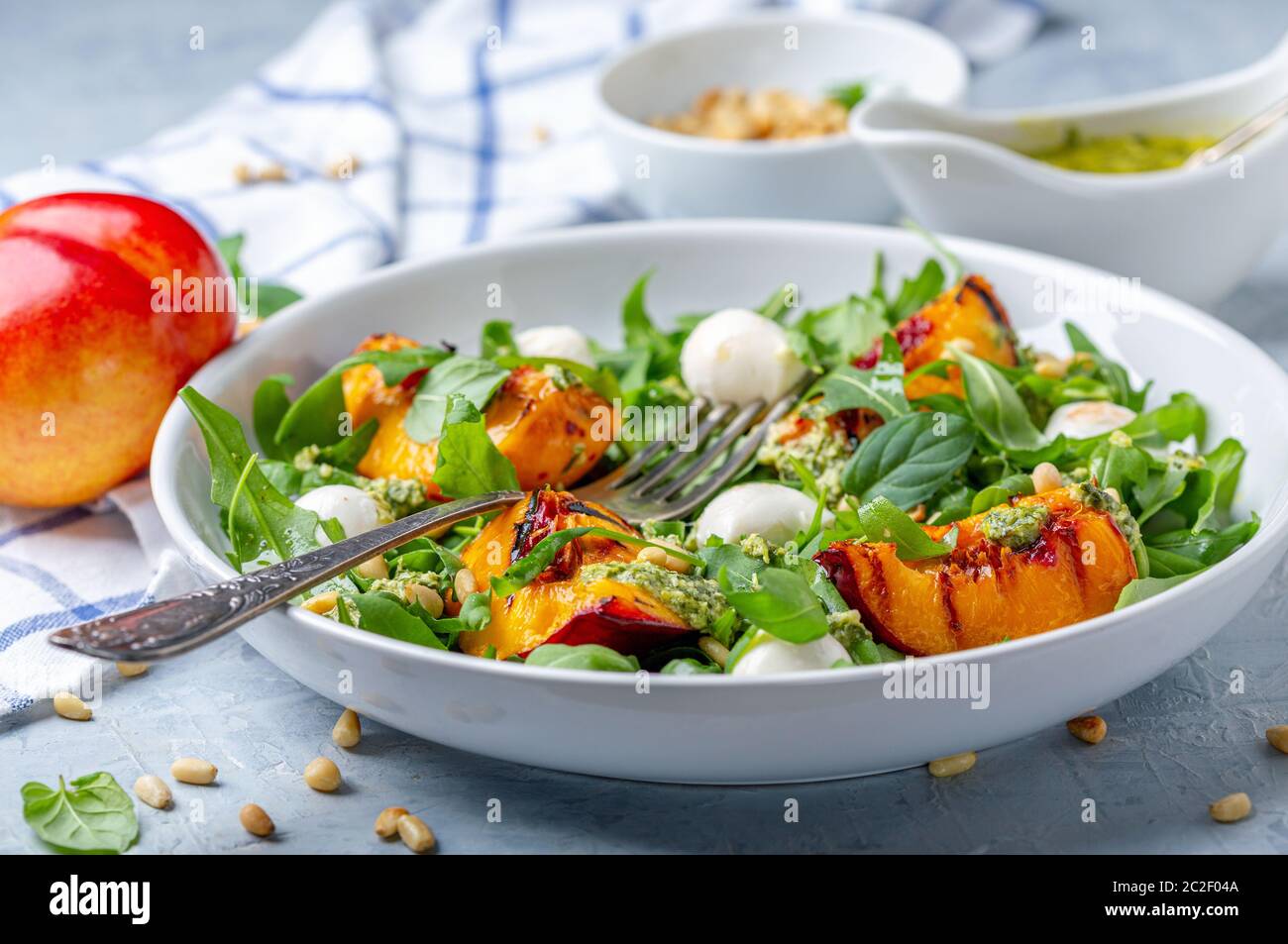 Arugula salad with grilled nectarines. Stock Photo