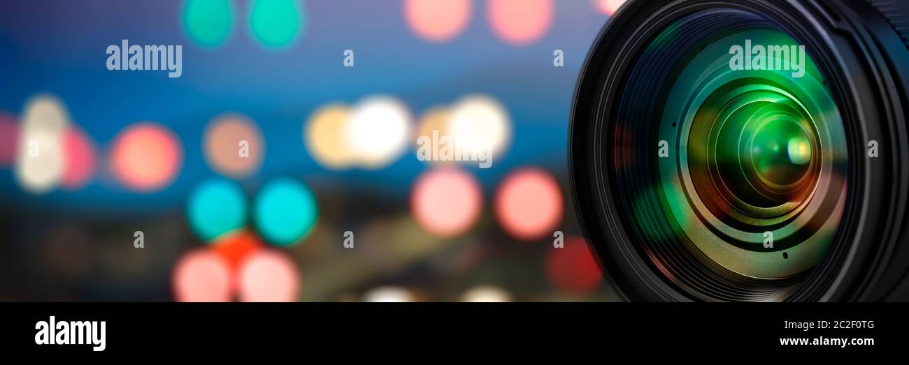 Camera lens with reflections on blur background Stock Photo - Alamy