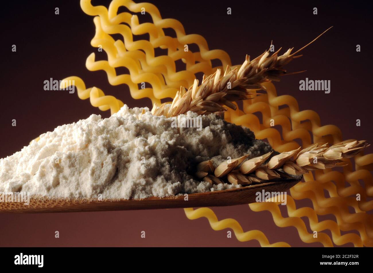 Flour with wheat ear and fusilli Stock Photo