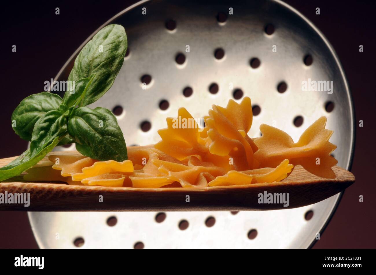 Uncooked farfalle pasta on the spoon Stock Photo
