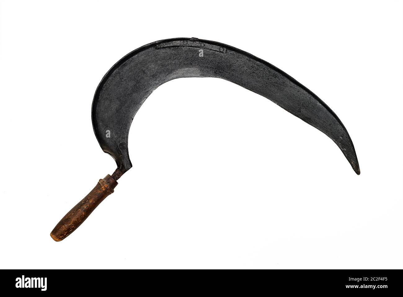 ancient hand made sickle on white background Stock Photo