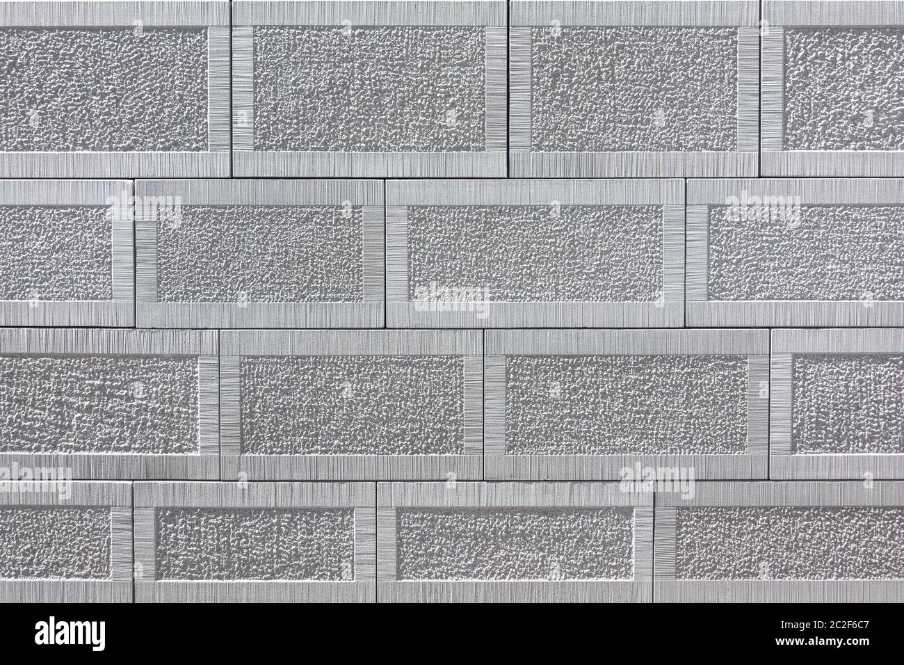 Detail of a wall of gray square sandstone with pattern, the rows have different heights Stock Photo