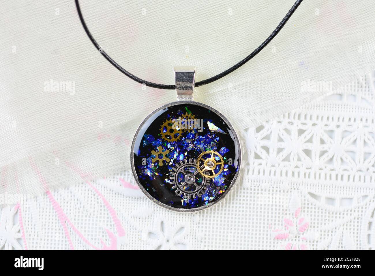 Steam Punk Style Pendant Necklace, Resin Art Multi Color Necklace, Resin pendant with cogs and timep Stock Photo
