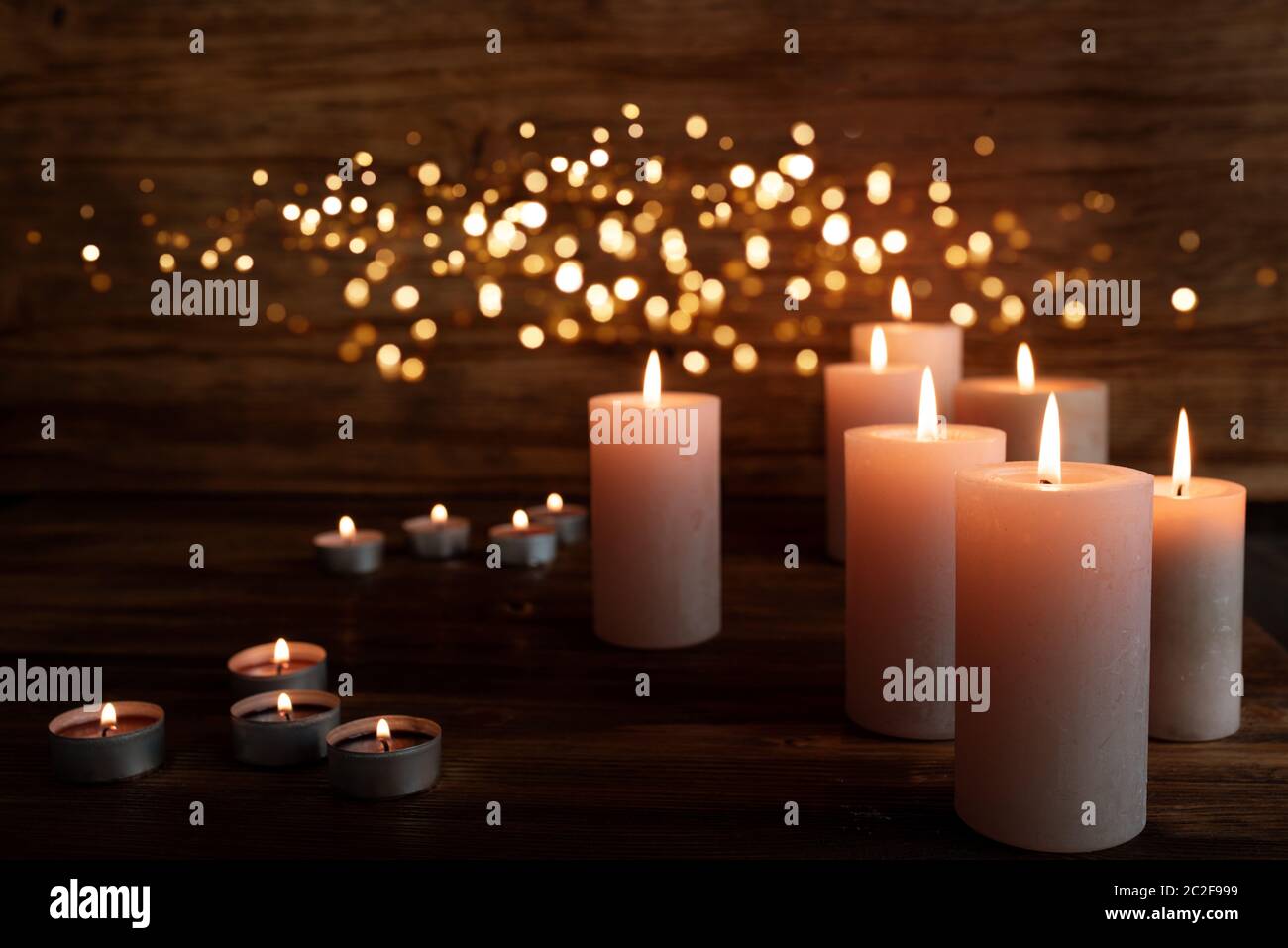 Burning candles in darkness with light effects Stock Photo Alamy