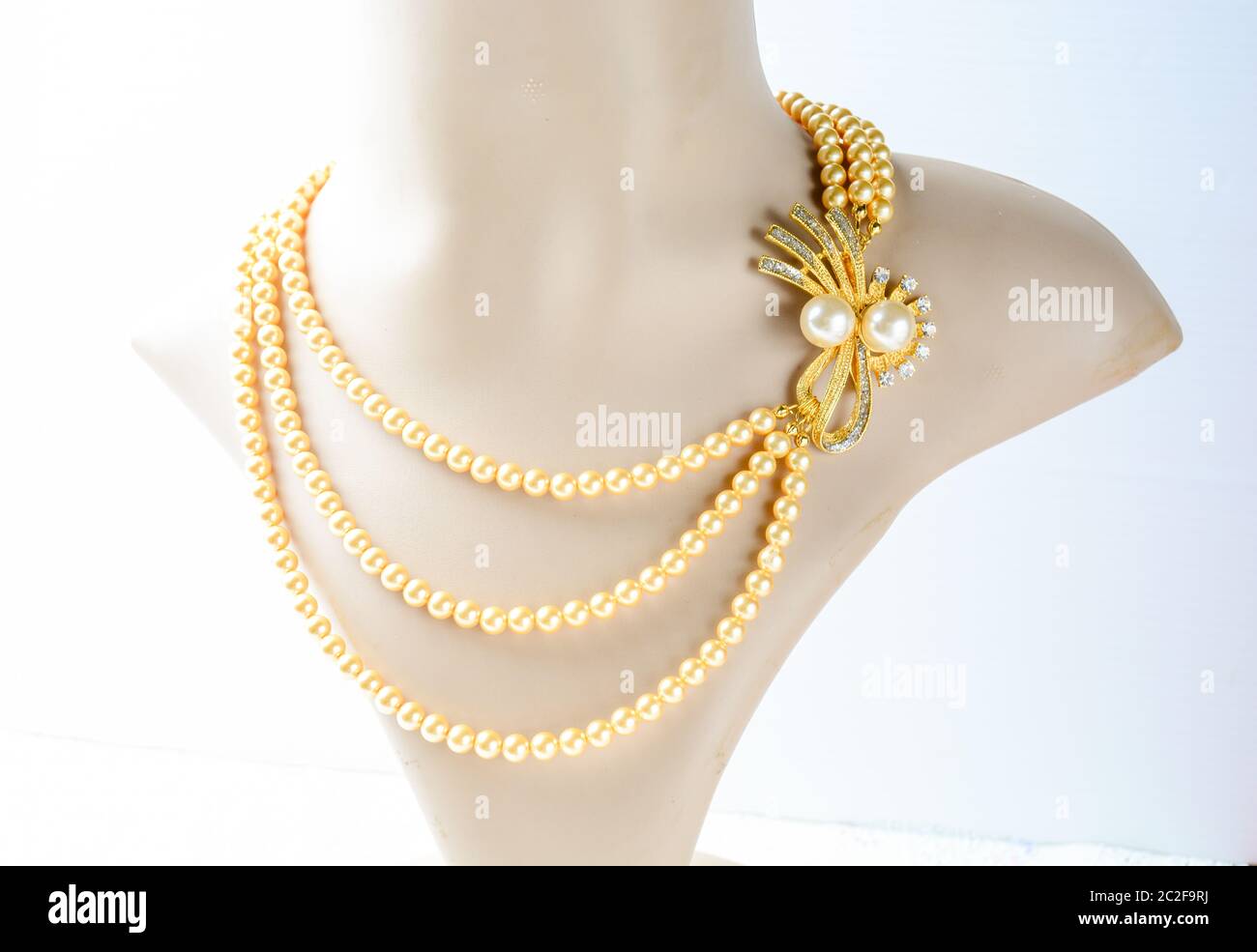Pearl necklace on mannequin and on white background Stock Photo