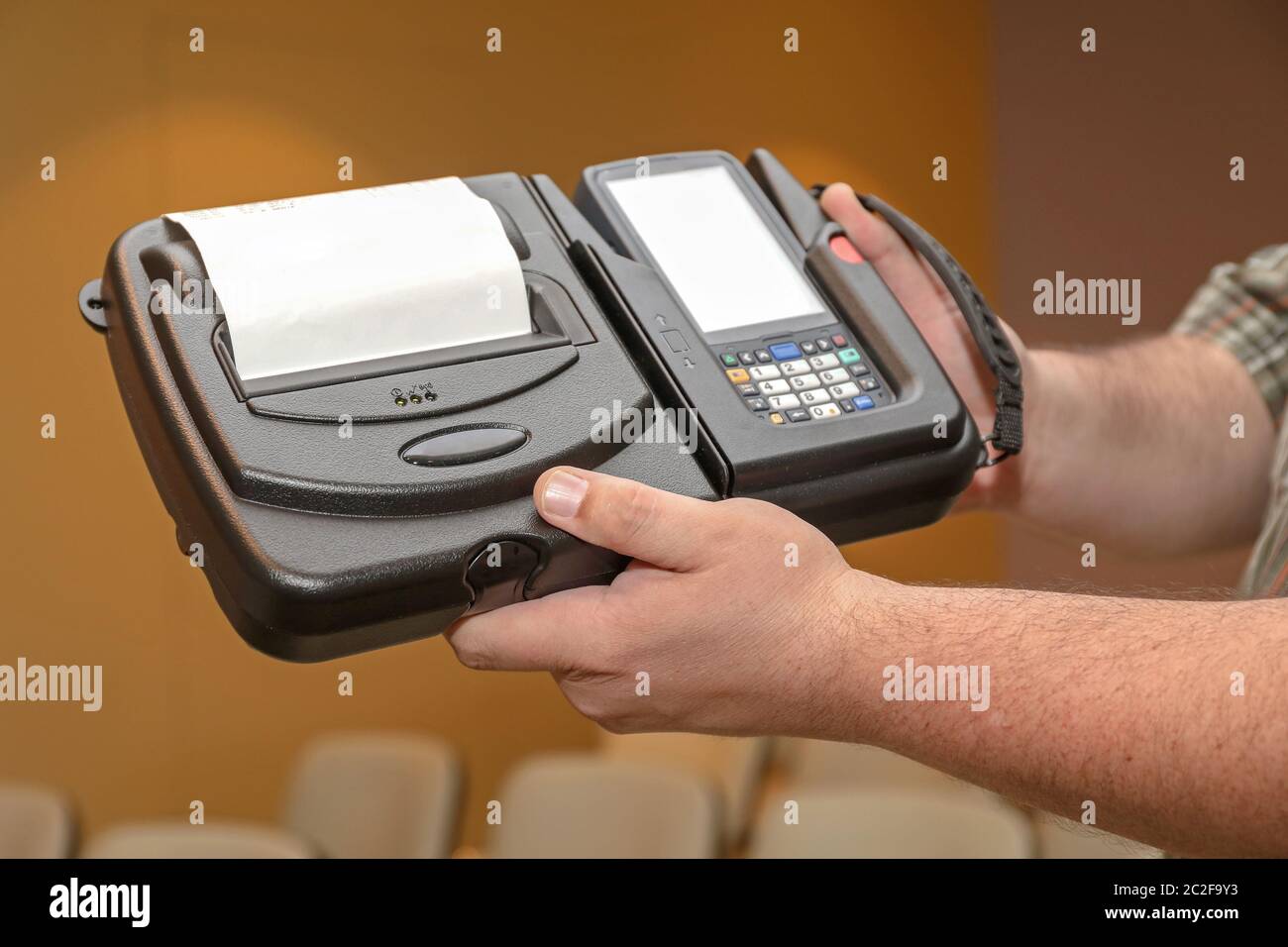 Man Holding Mobile Barcode Printer and Reader Computer Device Stock Photo
