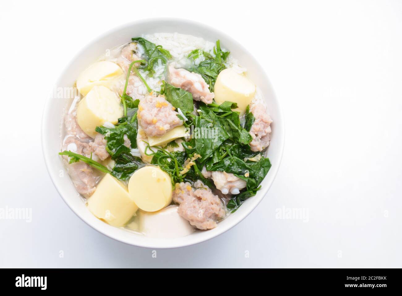 Boiled rice with pork, ivy gourd leaves and soft tofu Stock Photo