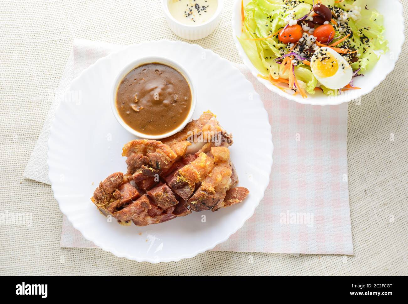 Deep fried pork knuckle with mushroom gravy source, fresh vegetable and salad cream source Stock