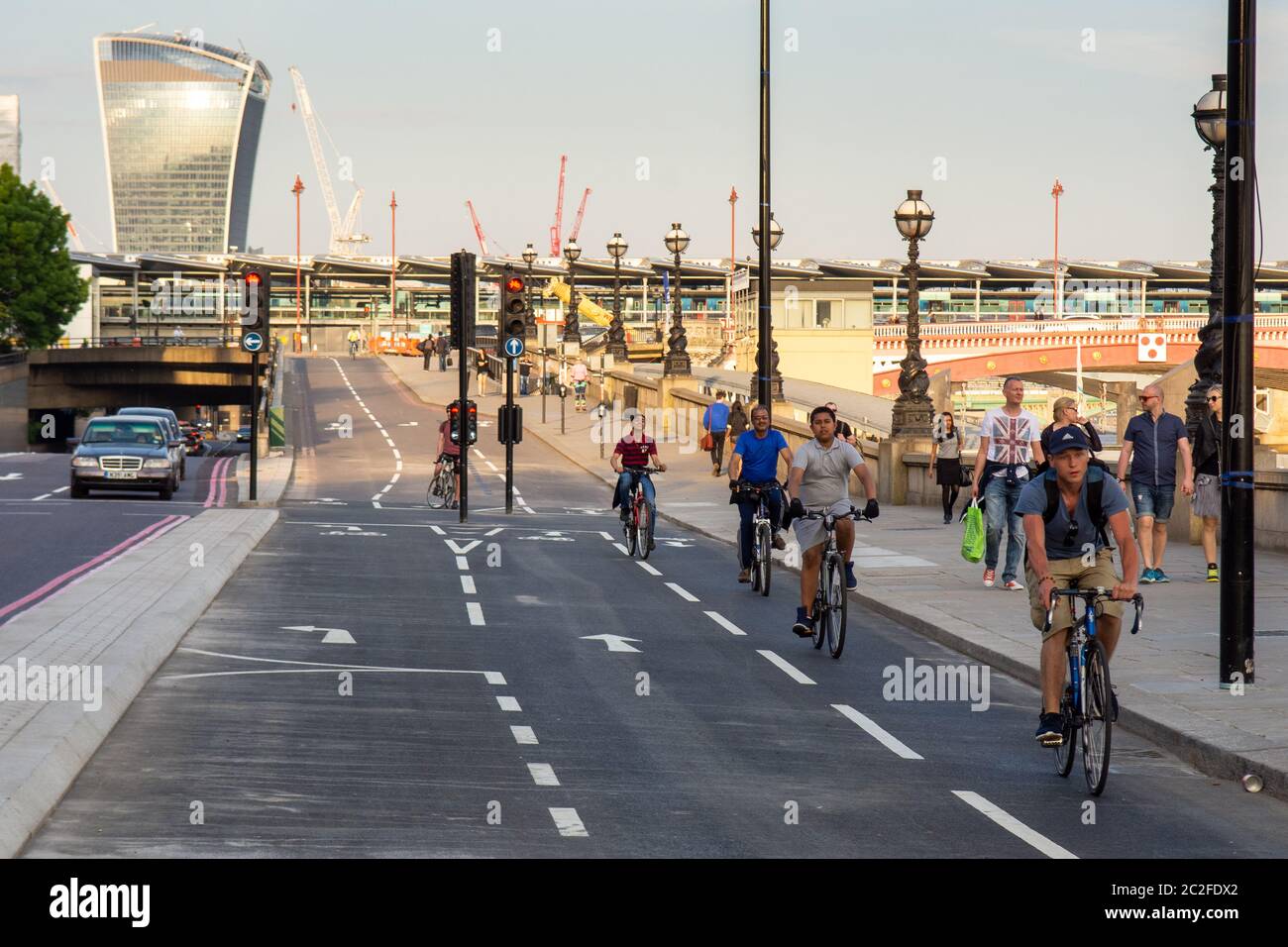 Cyclists ride along London's East-West 'Cycle Superhighway' along the River Thames Embankment at Blackfriars. Stock Photo
