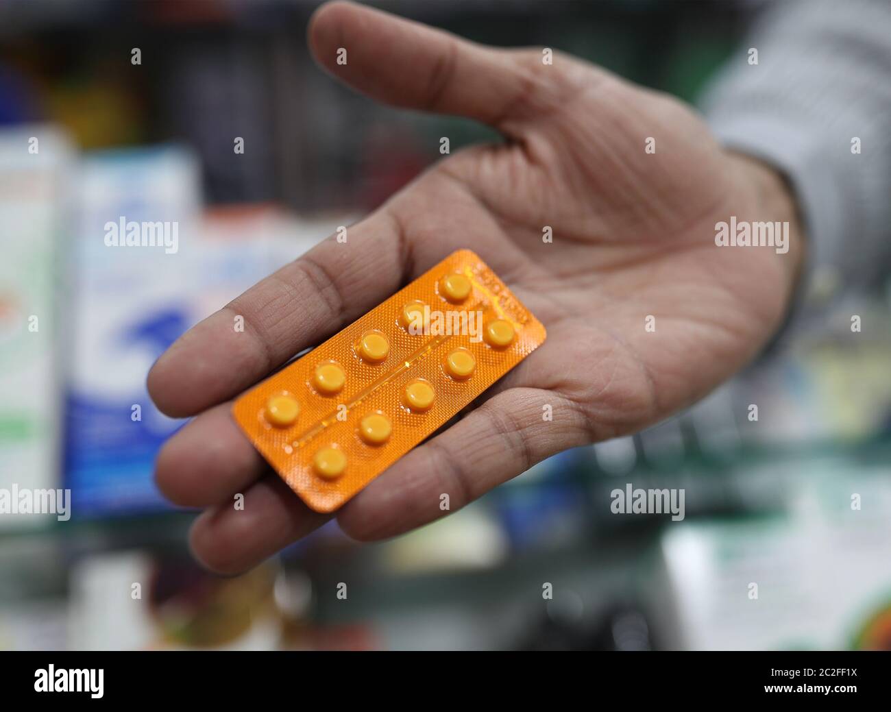 A member of staff at a pharmacy in London holds a packet of anti-inflammatory drug dexamethasone, which has been hailed as a ground-breaking treatment for hospital patients seriously ill with Covid-19. Researchers have found that the drug reduces deaths by up to a third among patients on ventilators and by a fifth for those on oxygen. Stock Photo