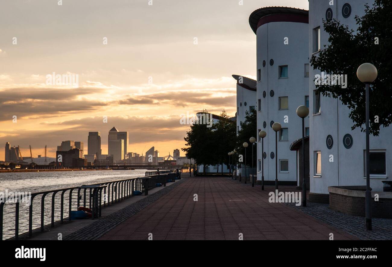 London, England, UK - July 31, 2010: The sun sets behind the skyline of London's Docklands business district and the University of East London buildin Stock Photo
