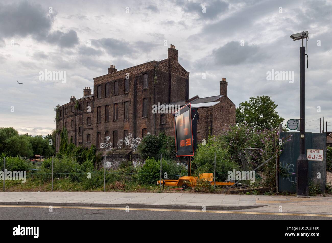 London, England, UK - July 13, 2010: Graffiti covers the boarded up and derelict Coal Office building awaiting redevelopment of the King's Cross goods Stock Photo