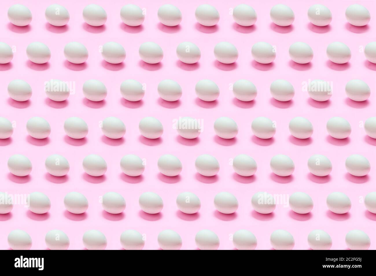 Many white eggs on solid color background Stock Photo
