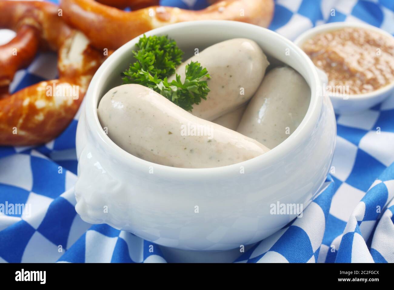 Traditional Bavarian Weisswurst On A Bavarian Flag Stock Photo