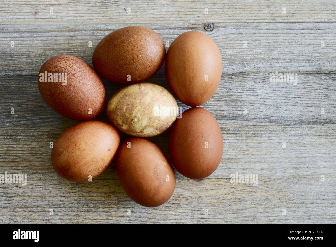 seven painted Easter eggs on a wooden background Stock Photo