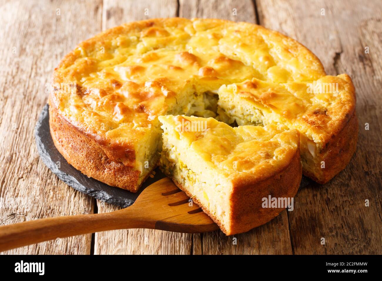 Traditional Russian sliced pie Kurnik close up on a slate board on the  table. vertical Stock Photo - Alamy