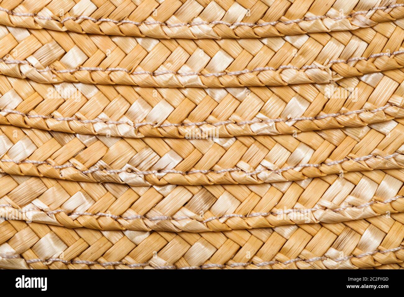 textile square background - detail of stitched summer straw hat from raffia fibers close up Stock Photo