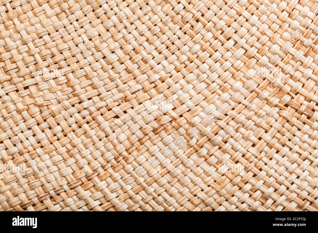textile background - texture of summer straw hat from natural raffia fibers close up Stock Photo