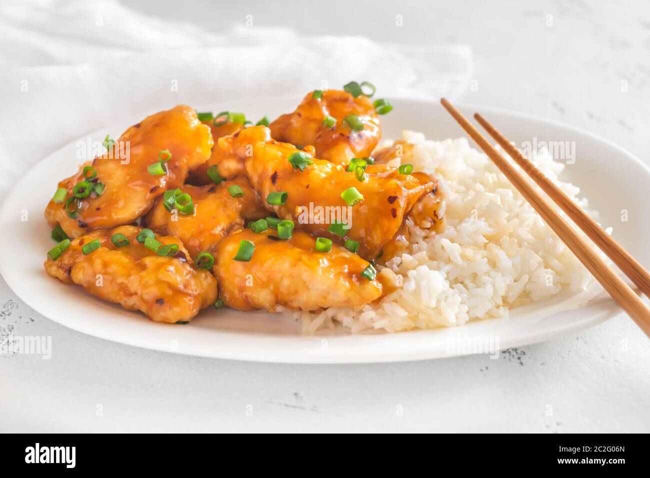 Portion of orange chicken and white rice Stock Photo - Alamy
