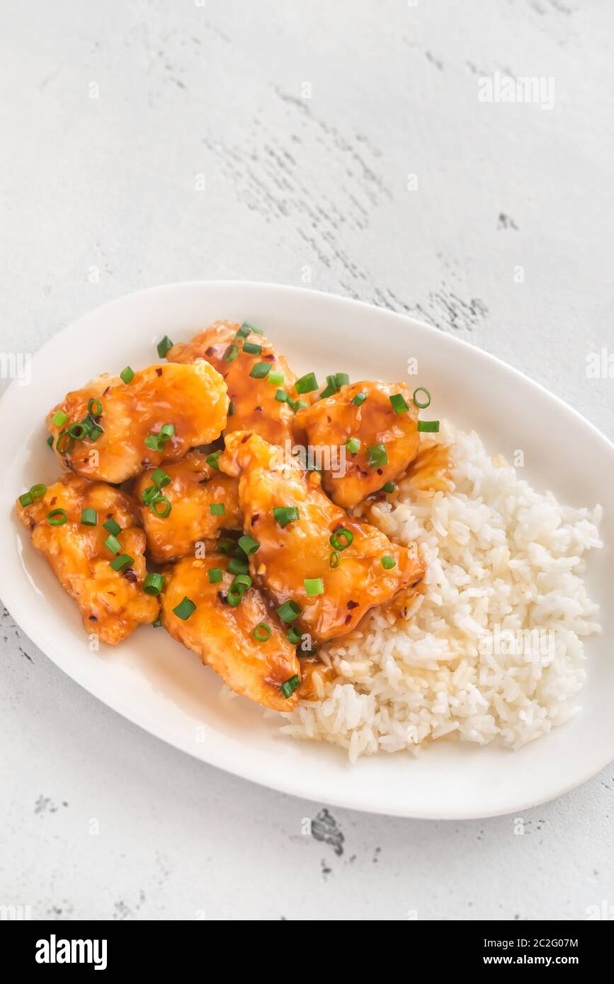 Portion of orange chicken and white rice Stock Photo - Alamy