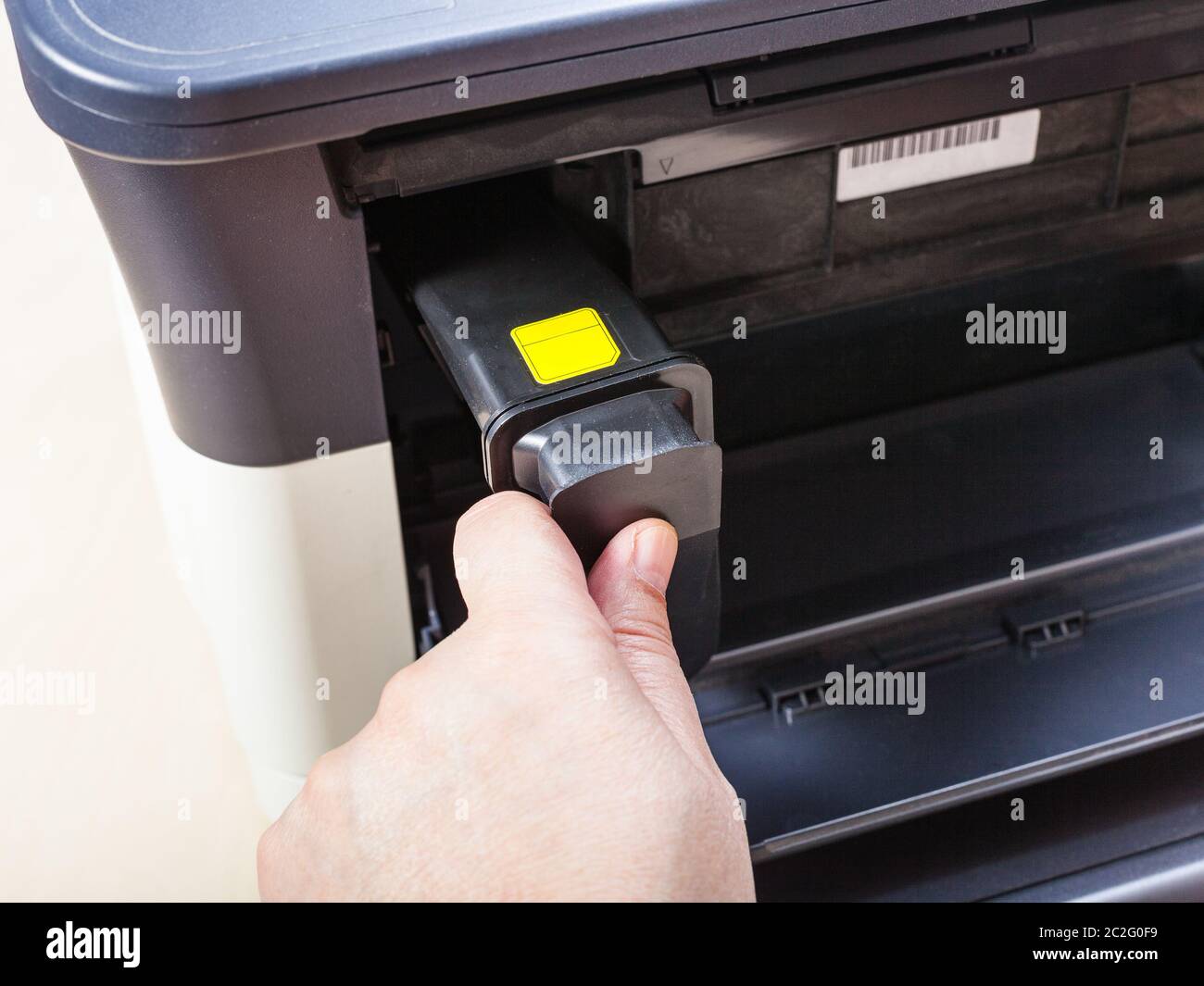 installing new toner cartridge in laser multi function device on table in office Stock Photo