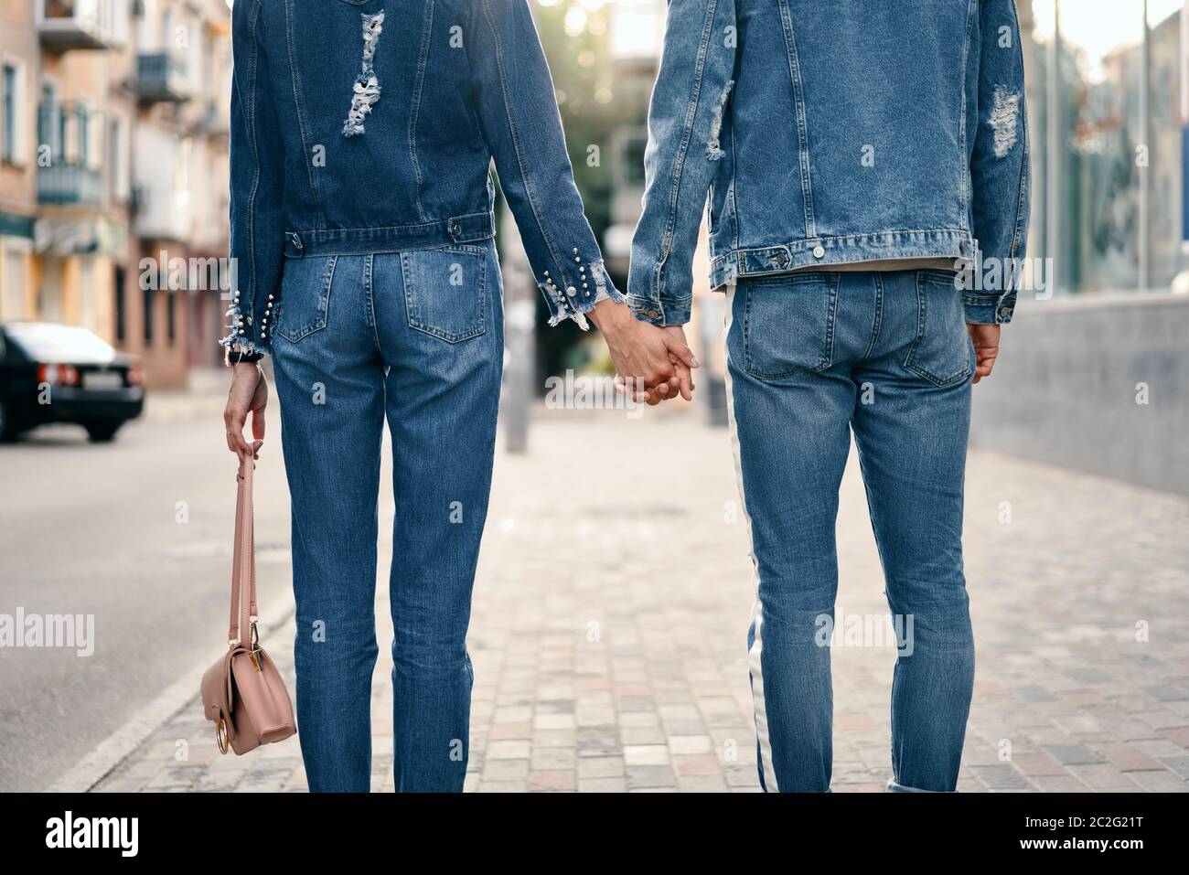Couple holding hands in city street Stock Photo - Alamy