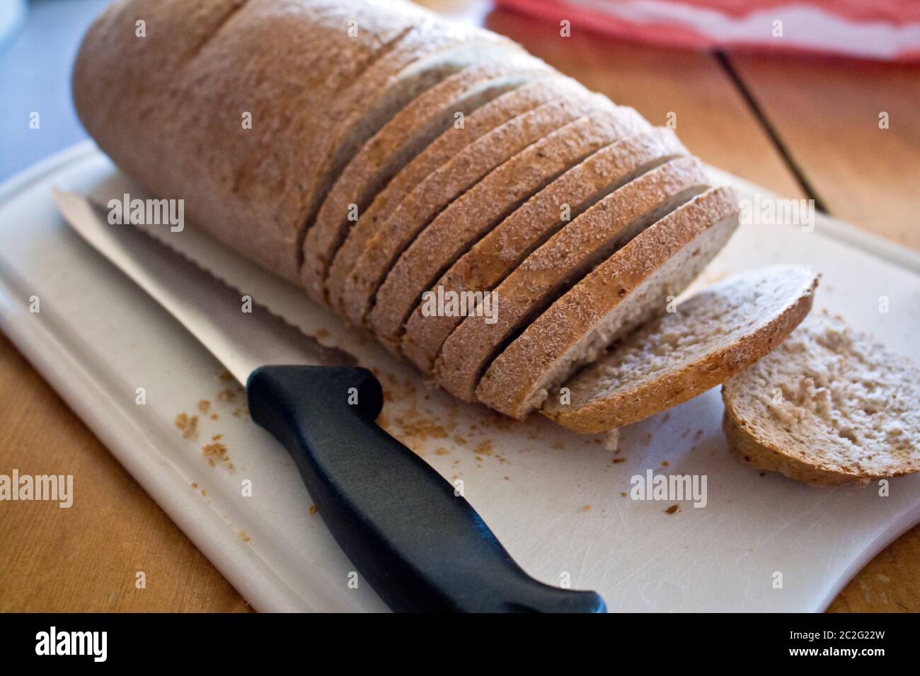 Wheat bread on cutting board with knife Stock Photo Alamy