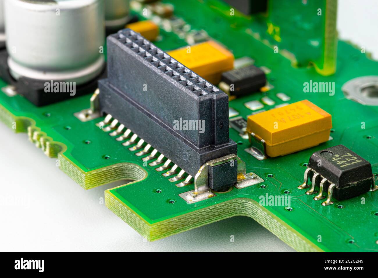 Macro photo of the integrated circuit on a green printed circuit board