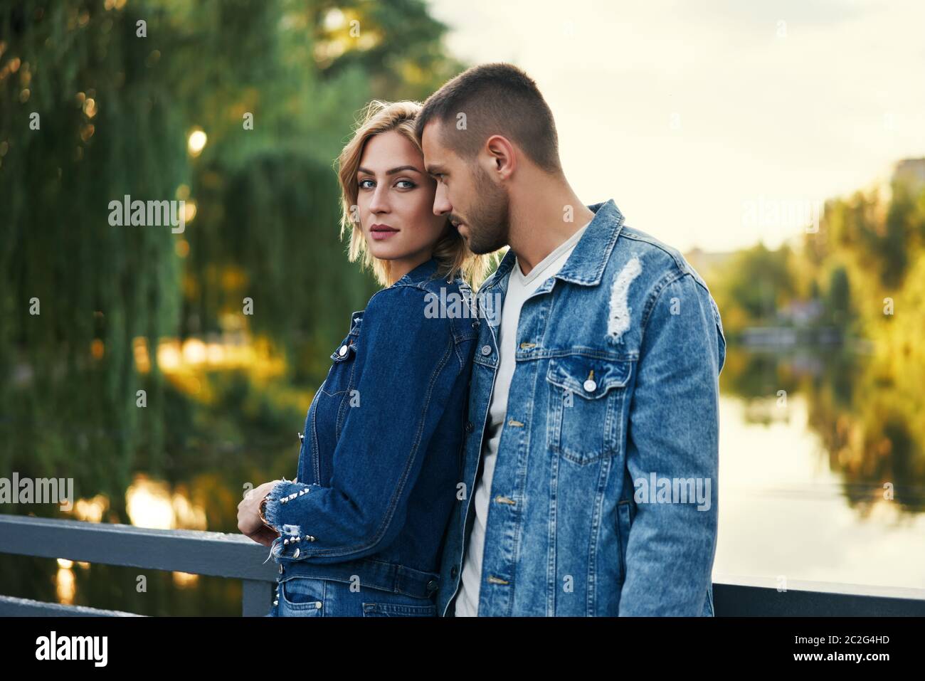 Young beautiful loving couple posing on nature Stock Photo