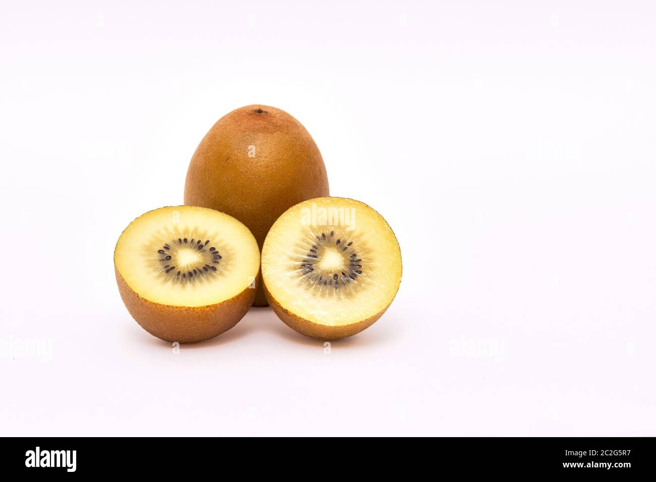 Sliced and whole Goden Kiwi fruits (Actinidia chinensis)  on a white background Stock Photo