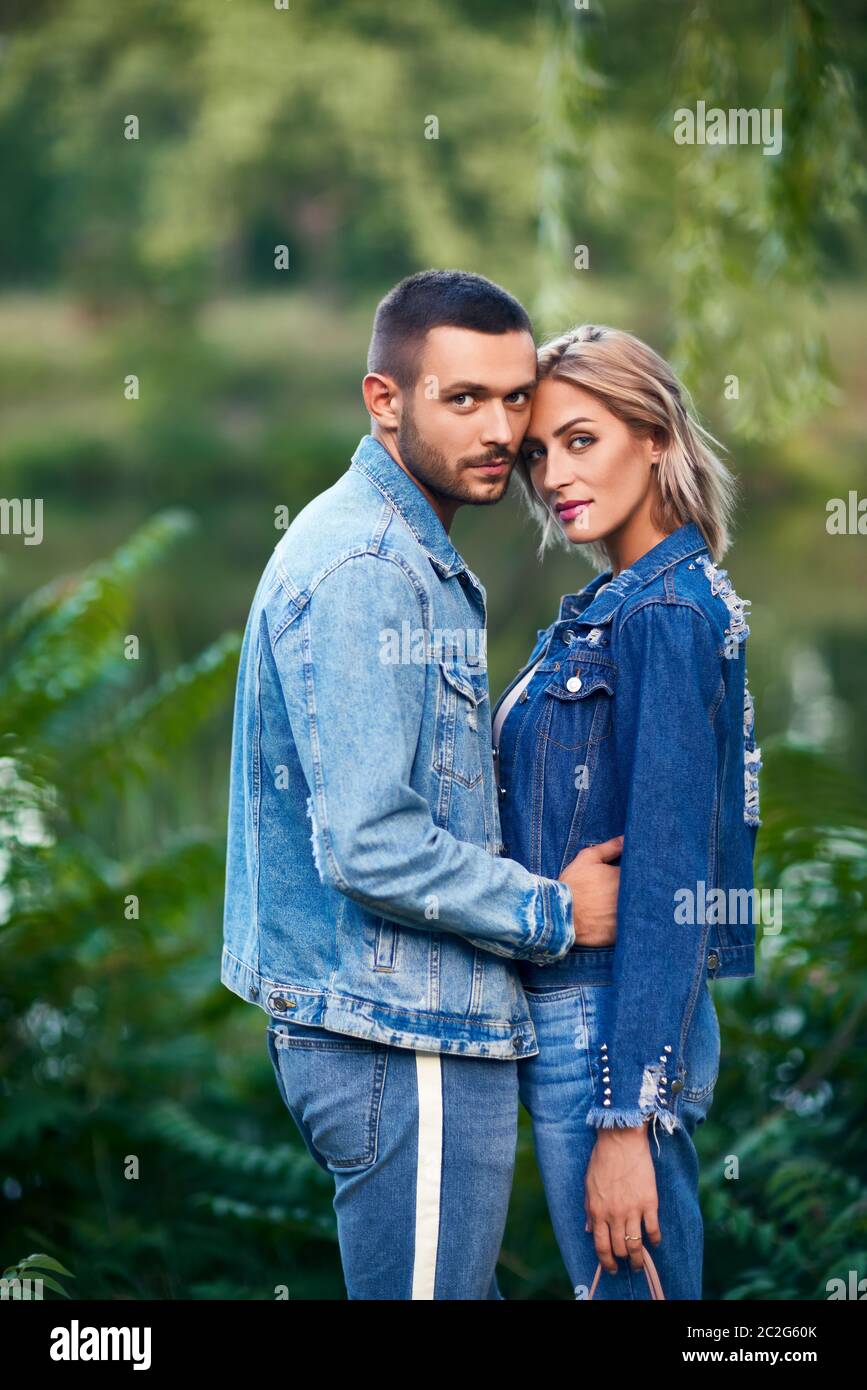 Young beautiful loving couple posing on nature Stock Photo