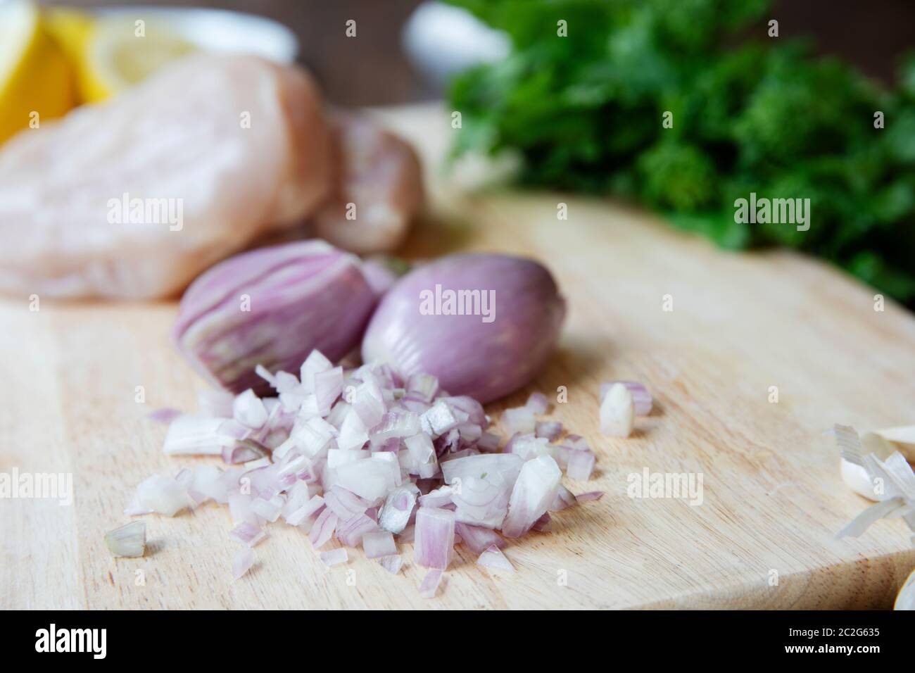 Fresh chopped shallots on a cutting board Stock Photo