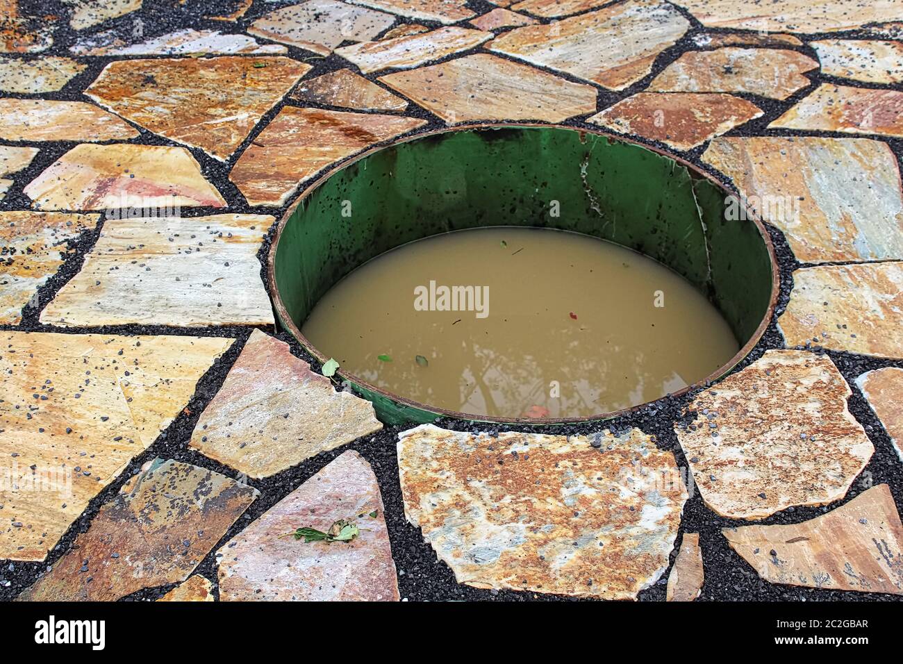 Closeup of a sunken firepit filled with water Stock Photo Alamy