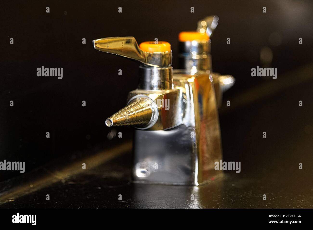 A lab gas valve on a black table and background Stock Photo Alamy